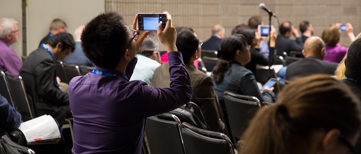 Man taking a picture during conference of dementia.