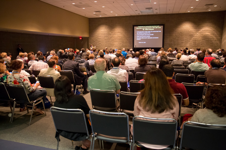 Attendees waiting for presentation related to neurology topic.