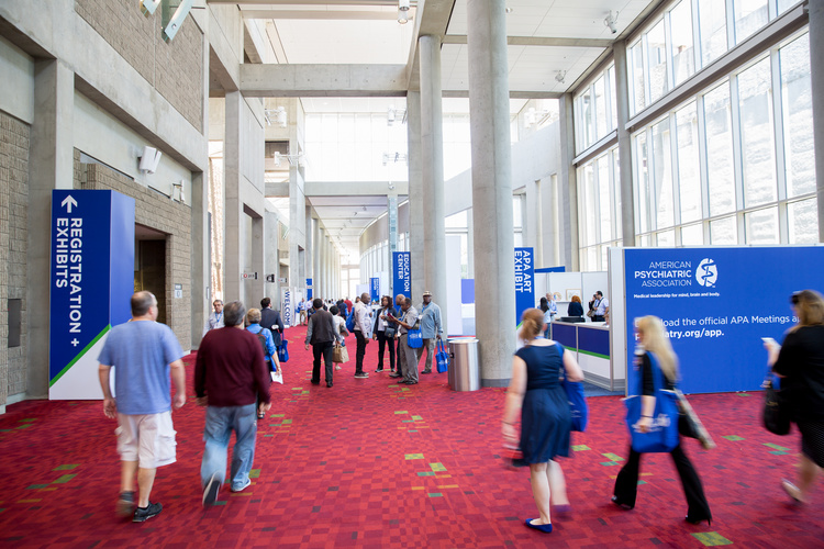 Participants in the corridor of a psychiatry conference.